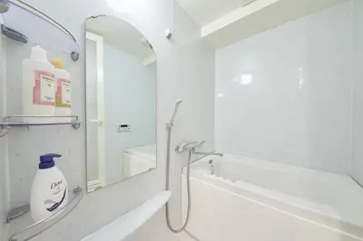 a bathroom with a bath tub and a mirror at Shinjuku Kabukicho Designer's Apartment IV in Tokyo