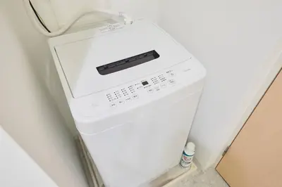 a white washer and dryer in a refrigerator at Shinjuku Kabukicho Designer's Apartment IV in Tokyo