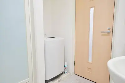 a bathroom with a door and a toilet and a sink at Shinjuku Kabukicho Designer's Apartment V in Tokyo