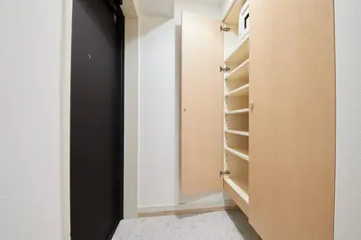 a walk in closet with a black door and shelves at Shinjuku Kabukicho Designer's Apartment V in Tokyo
