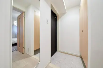 a hallway with white walls and a mirror at Shinjuku Kabukicho Designer's Apartment V in Tokyo