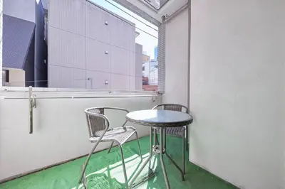 a small table and two chairs on a balcony at Shinjuku Kabukicho Designer's Apartment VI in Tokyo
