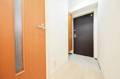 a hallway with a black door and a mirror at Shinjuku Kabukicho Designer's Apartment VI in Tokyo