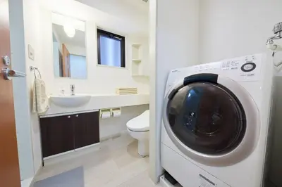 a washing machine in a bathroom with a sink at Shinjuku Kabukicho Designer's Apartment VI in Tokyo