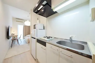 a kitchen with a sink and a refrigerator at Shinjuku Kabukicho Designer's Apartment VI in Tokyo