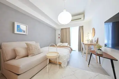 a living room with a bed and a couch at Shinjuku Kabukicho Designer's Apartment VII in Tokyo