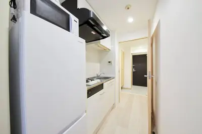 a kitchen with white cabinets and a sink at Shinjuku Kabukicho Designer's Apartment VII in Tokyo