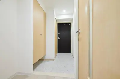 a hallway with a black door and a room with a floor at Shinjuku Kabukicho Designer's Apartment VII in Tokyo
