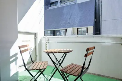 two chairs and a table on a balcony at Shinjuku Kabukicho Designer's Apartment VII in Tokyo
