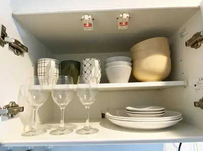 a shelf with wine glasses and plates and dishes at Very near Skytree Asakusa Newly build apartment 102 in Tokyo