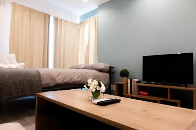 a living room with a tv and a coffee table at Skyfeel Okubo A in Tokyo