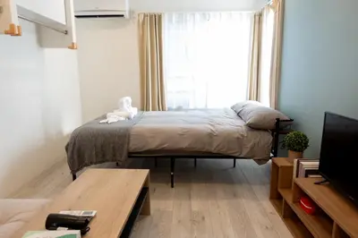 a small bedroom with a bed and a window at Skyfeel Okubo A in Tokyo