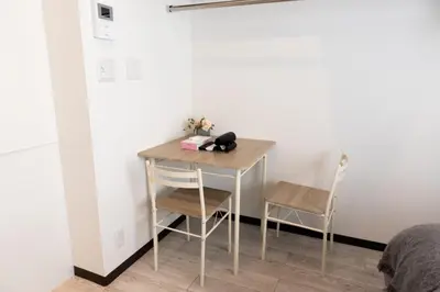 a small table in a room with two chairs at Skyfeel Okubo A in Tokyo