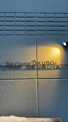 a sign on the side of a building with the words olivario at Skyfeel Okubo A in Tokyo