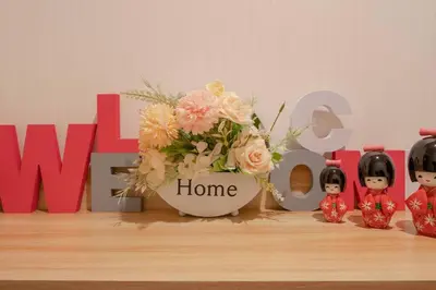 a vase of flowers in front of a home sign at 12 MIN walk to Shinjuku STR ,6 MIN Higashishinjuku ,nearest kabukicho ,shinjuku oen, in Tokyo