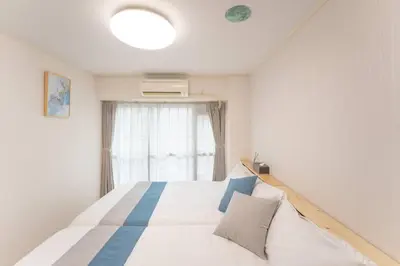 a bedroom with a large white bed with a window at 12 MIN walk to Shinjuku STR ,6 MIN Higashishinjuku ,nearest kabukicho ,shinjuku oen, in Tokyo