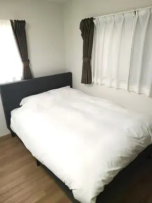 a white bed in a bedroom with a window at 9, Minamisuna 2, Entire house for rent, \u5357\u78022 in Tokyo