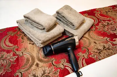 a blow dryer and two towels on a table at 9, Minamisuna 2, Entire house for rent, \u5357\u78022 in Tokyo