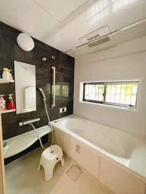 a bathroom with a white tub and a sink at JINGHOUSE Takasago detached house - Vacation STAY 17050 in Tokyo