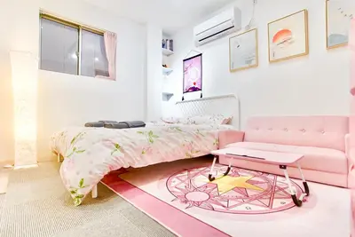 a bedroom with a pink bed and a pink couch at \u8c4a\u5cf6\u6c11\u5bbf206 in Tokyo