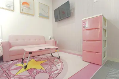 a pink room with a table and a pink refrigerator at \u8c4a\u5cf6\u6c11\u5bbf206 in Tokyo
