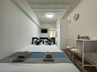 a bedroom with a bed with towels on it at nestay inn tokyo waseda in Tokyo