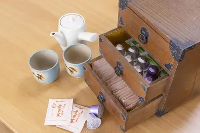 a wooden box with cups and mugs on a table at Komorebi in Tokyo