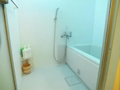 a bathroom with a shower and a tub and a sink at Komorebi in Tokyo