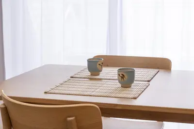 two cups on a table with two chairs at Komorebi in Tokyo