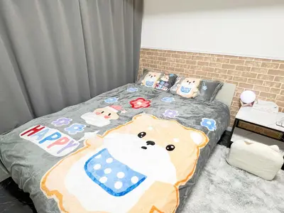 a bedroom with a bed with a teddy bear blanket at Ikebukuro Sugamo 203 in Tokyo