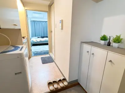 a small kitchen with a door leading to a bedroom at Ikebukuro Sugamo 203 in Tokyo
