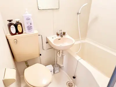 a small bathroom with a toilet and a sink at Ikebukuro Sugamo 203 in Tokyo
