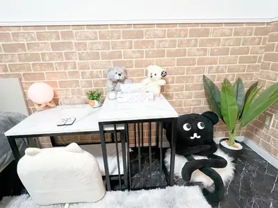 a table with two teddy bears sitting at it at Ikebukuro Sugamo 203 in Tokyo