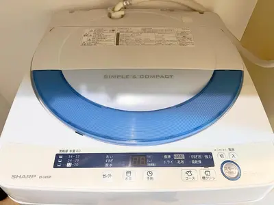 a washing machine with a blue lid on a scale at Ikebukuro Sugamo 203 in Tokyo