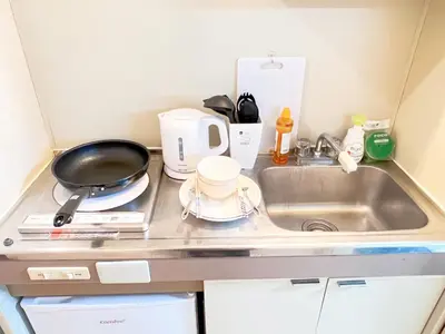a small kitchen with a sink and a stove at Ikebukuro Sugamo 203 in Tokyo