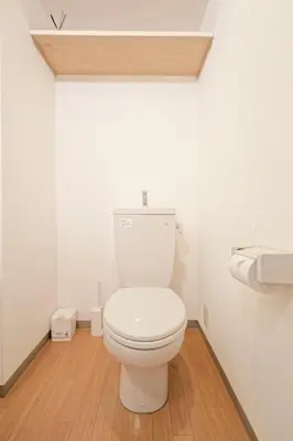 a white toilet in a bathroom with a wooden floor at Mi-APT MIDORI in Tokyo