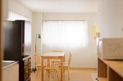 a kitchen with a table and chairs and a window at Mi-APT MIDORI in Tokyo