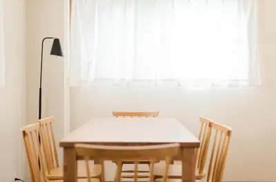 a dining room table with chairs and a window at Mi-APT MIDORI in Tokyo