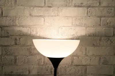 a white lamp in front of a brick wall at \u30a2\u30f3\u30c9\u30b9\u30c6\u30a4\u3059\u3082\u3046\u30db\u30c6\u30eb402 in Tokyo