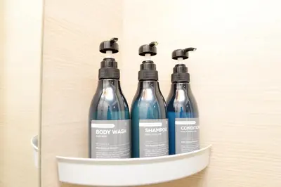 a group of four bottles in a cabinet at \u548c\u306e\u6953cottage\u7b2c\u4e8c202 \u65b0\u5bbf\u6b4c\u821e\u4f0e\u753a\u8fd1\u96a3 in Tokyo