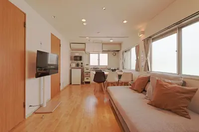 a living room with a couch and a kitchen at V Close to Shinjuku Kabukicho Korean Town FrWIFI E in Tokyo