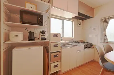 a small kitchen with a sink and a microwave at V Close to Shinjuku Kabukicho Korean Town FrWIFI E in Tokyo