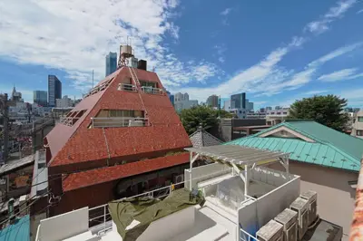 a building with a brick tower on top of a building at V Close to Shinjuku Kabukicho Korean Town FrWIFI E in Tokyo