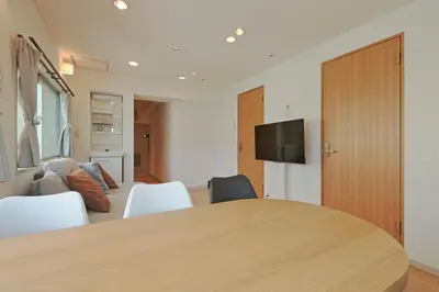 a room with a table and chairs and a tv at V Close to Shinjuku Kabukicho Korean Town FrWIFI E in Tokyo