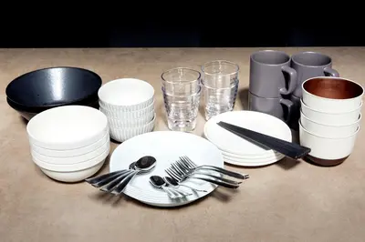 a table with white plates and utensils on it at Luxury stay at Himonya House in Tokyo