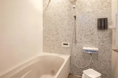 a white bathroom with a tub and a toilet at Luxury stay at Himonya House in Tokyo
