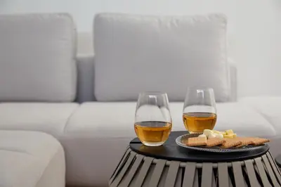two glasses of wine and a plate of food on a table at Luxury stay at Himonya House in Tokyo
