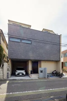 a car parked in front of a building with a garage at Luxury stay at Himonya House in Tokyo