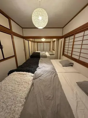 a bedroom with two beds in it with a chandelier at Style Lab\u304a\u82b1\u8336\u5c4b2 in Tokyo