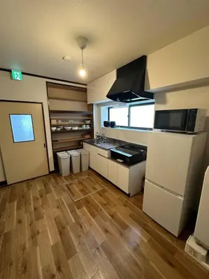 a kitchen with white appliances and a wooden floor at Style Lab\u304a\u82b1\u8336\u5c4b2 in Tokyo